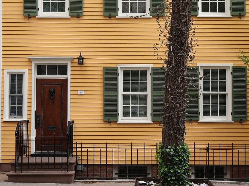 yellow house with green shutters