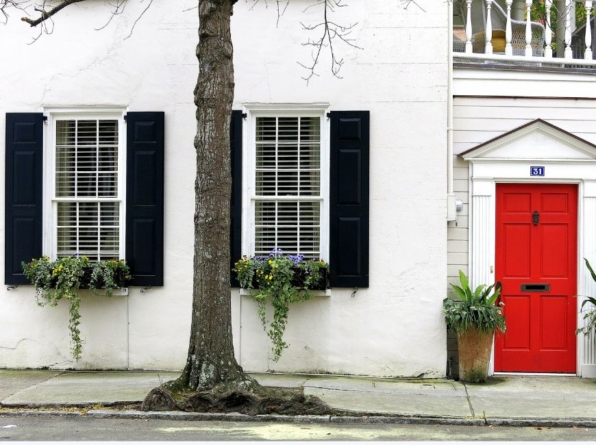 white house with red door and black shutters