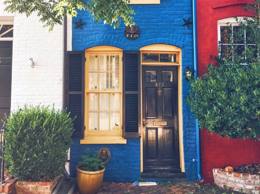 white blue and red row houses with navy shutters